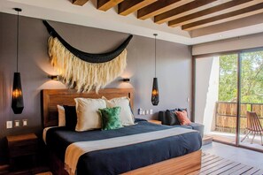 Relax in a comfy king bed, AC, ceiling fan, and private balcony with jungle views!