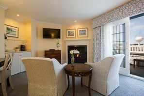 Cozy seating by the fireplace offers the perfect setting for unwinding in comfort and style.