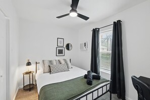 “Cozy Queen Bedroom with Workspace”
Unwind in a comfy queen bed with blackout curtains and stylish touches. 