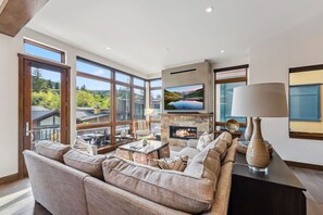 Spacious Living Room with Comfy Seating, Spectacular Floor to Ceiling Views, Gas Fireplace and Large Smart TV