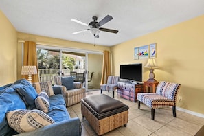 Cozy living room with flat screen T.V. & outside views