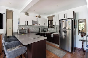 The large kitchen has a breakfast bar for dining or working.