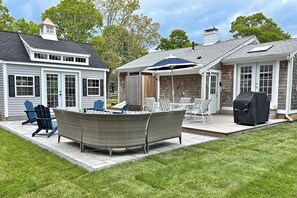Beautiful backyard with deck and patio, seating, dining table, grill and outdoor shower