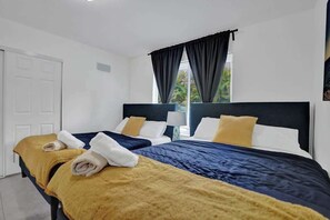 Bedroom four features two comfortable queen beds