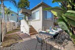 Spacious patio with a dining table set for 8, perfect for outdoor gatherings