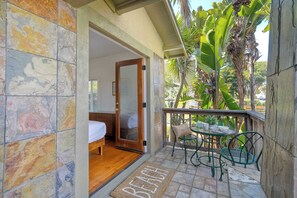 Spacious queen bedroom with French doors leading to a private balcony