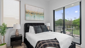 Stylish queen bedroom with patio access