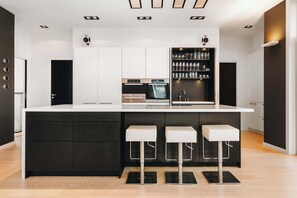 High-end kitchen featuring a combination of white and dark cabinetry.
