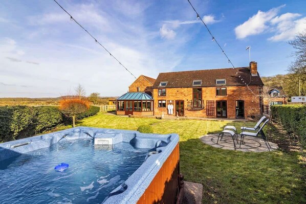 Nature’s embrace, unwind in the hot tub with nature all around, offering a tranquil escape from the world