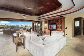 Unwind in the inviting living area with plush seating and a rich wood-paneled ceiling.