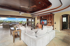 Unwind in the inviting living area with plush seating and a rich wood-paneled ceiling.
