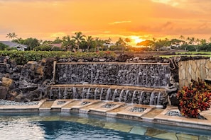 Golden hour lights up the cascading waterfall, creating a tranquil, picture-perfect setting.