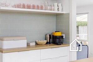 Well-equipped kitchen with Nespresso Vertuo coffee pod machine