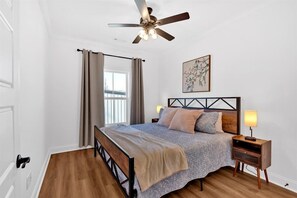 A spacious king bedroom with a brand new mattress