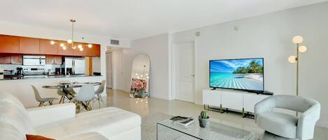 Pristine living room enriched with an abundance of natural light from floor to ceiling window!