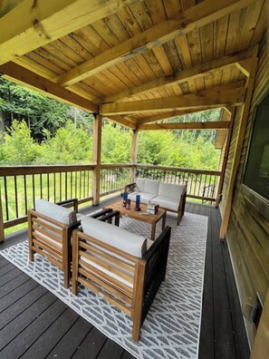 Backyard covered deck with ample seating.