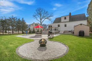 Backyard compete with firepit, huge patio with grill, cornhole, 2 patio tables!