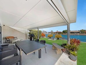 Dine alfresco under the covered patio with stunning canal views and a BBQ close at hand—ideal for leisurely afternoons or evening sunsets.