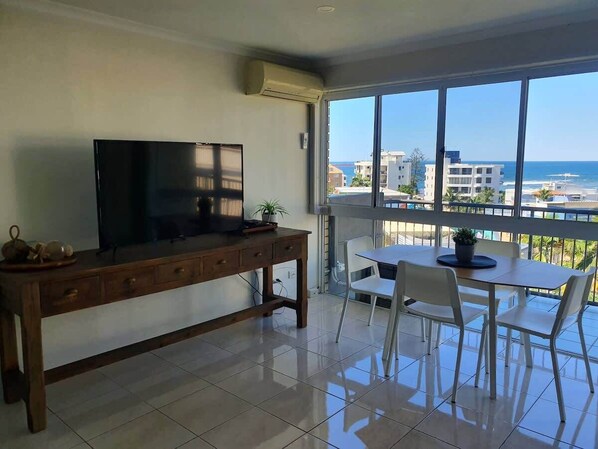 Unwind in the bright, breezy living space with comfy seating, a Smart TV, and incredible coastal views.
