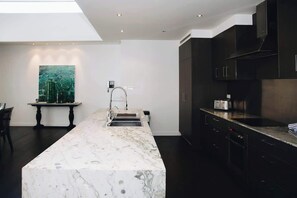 The central stone island is perfect for cooking, gathering, and creating memories