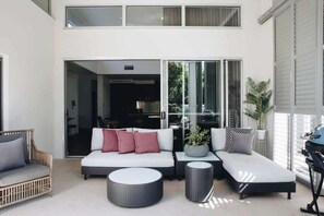 The enclosed patio invites slow afternoons, with lounge seating and a BBQ that make it a great spot to unwind with a drink or casual meal.

