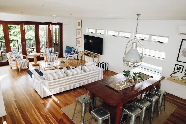 The open-plan design seamlessly connects the dining area to the living space.