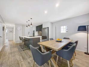 The timber dining table comfortably seats six guests for meals at home.