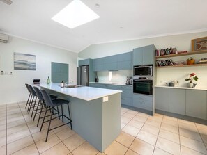 The kitchen centres around an island with seating for four.