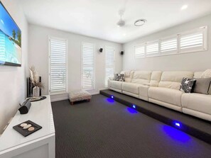 Settle in for movie nights with leather recliners, surround sound, and moody under-floor lighting—your private cinema awaits.