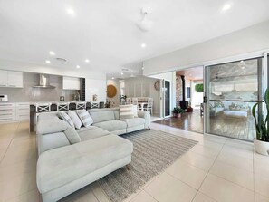 Unwind together in the open-plan living space, where coastal comfort meets modern style—perfect for family moments and evening chats.