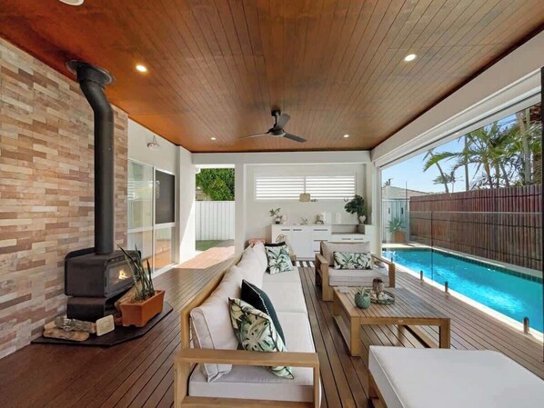 Cosy up on the outdoor lounge by the wood-burning fireplace.