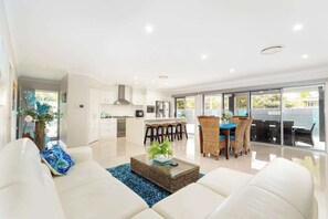 A second living area off the kitchen provides even more space to unwind, play games, or enjoy a quiet moment with a book.