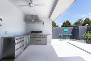 Soak up island vibes in your private outdoor oasis, complete with a BBQ kitchen, dining area, and comfy seating.