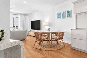Gather around the indoor dining table with seating for four—ideal for shared meals, board games, or planning your next Sunshine Coast adventure.