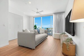 Unwind in a sunlit lounge where comfort meets coastal calm—stream your favourite shows on the Smart TV or curl up with a book as sea breezes drift in from the balcony.