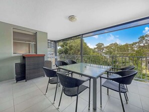 Enjoy sunset drinks or alfresco meals on the oversized balcony with lush green views, outdoor seating for six, and a BBQ for easy entertaining.