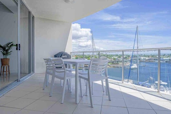 Dine alfresco, sip coffee, or watch boats drift by from the balcony overlooking the calm marina waters.