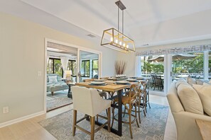 Just an 8-minute walk to the beach, this completely renovated gem features a chef's kitchen, designer decor, and seamless indoor-outdoor living with a 4-season sunroom and outdoor deck to enjoy Lowcountry nature.