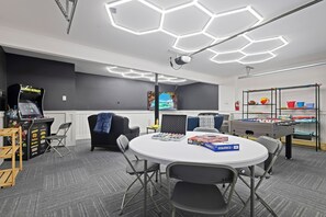 This home features an additional game room, with leather sofas, a flat screen TV, a table for card or board games, as well as a Retro Arcade Machine and foosball table.