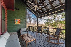 Covered porch with ceiling fan and comfortable seating