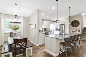 The dining room table comfortably sits 8 guests and the kitchen island seats an additional 4 people.