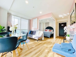Bright and airy living room with wrap around balconies in every room. 