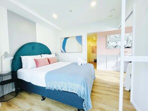 Rest easy and breathe freely in our cozy retreat, featuring premium mattresses and pillows encased in top-quality anti-mite protectors for your ultimate comfort and health. 

Bedroom opens up to a balcony. 