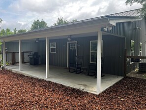 Front porch and entry includes a gas BBQ and 2 rocking chairs.