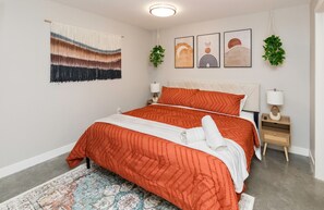Main level bedroom w/ King Plush Pillowtop Bed, 50" Roku Smart TV & Walk-In Closet