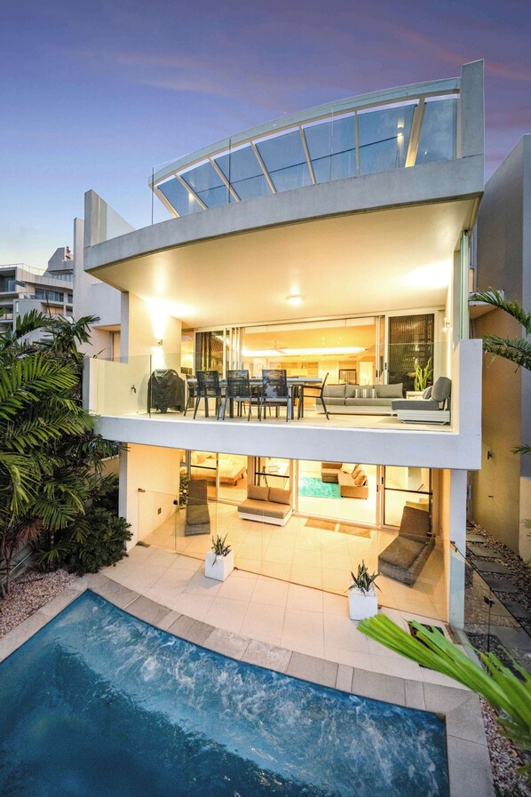 This stunning beachfront home spans three levels of living and sleeping areas, plus a rooftop terrace and a private underground garage