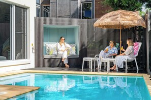 The pool area offers plenty of seating for sunbathing, along with a cosy alcove perfect for relaxing in the shade.