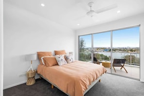 Wake up to gentle sea breezes in the primary queen bedroom with balcony access and crisp coastal styling.