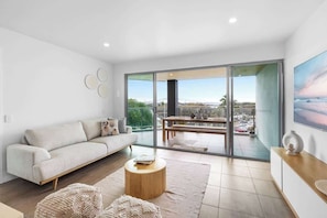 Relax in the light-filled living space that flows seamlessly onto the covered balcony.