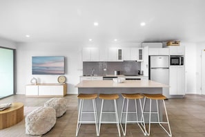 Cook with ease in the fully equipped kitchen, complete with island bench seating and modern appliances.